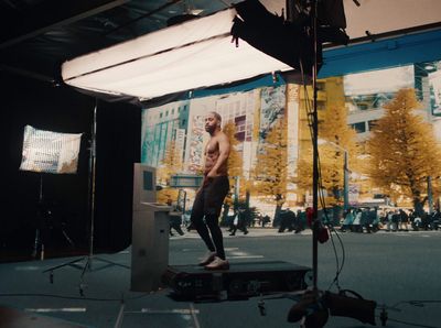 a man standing on top of a box in front of a camera