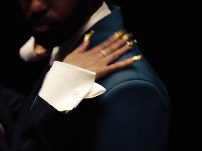 a close up of a person wearing a suit and tie