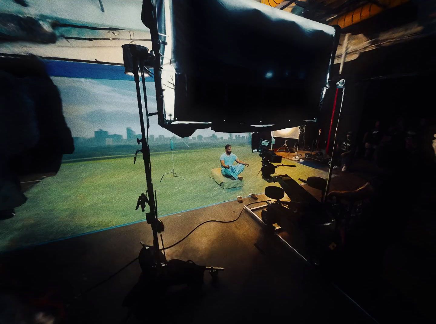 a man sitting on a chair in front of a television