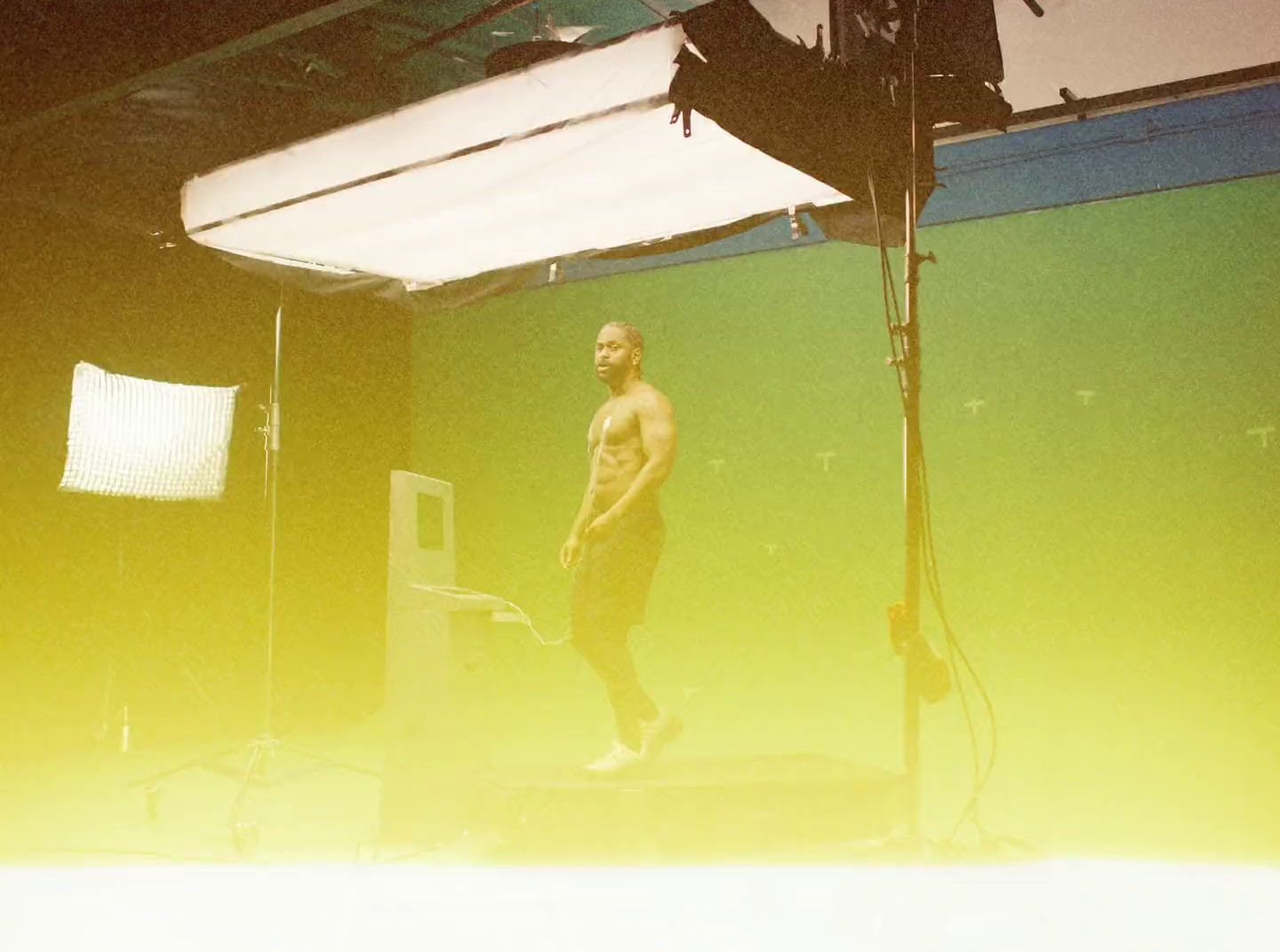 a man standing on a stage in front of a green screen