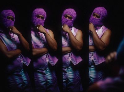 a person wearing a purple outfit and a purple mask