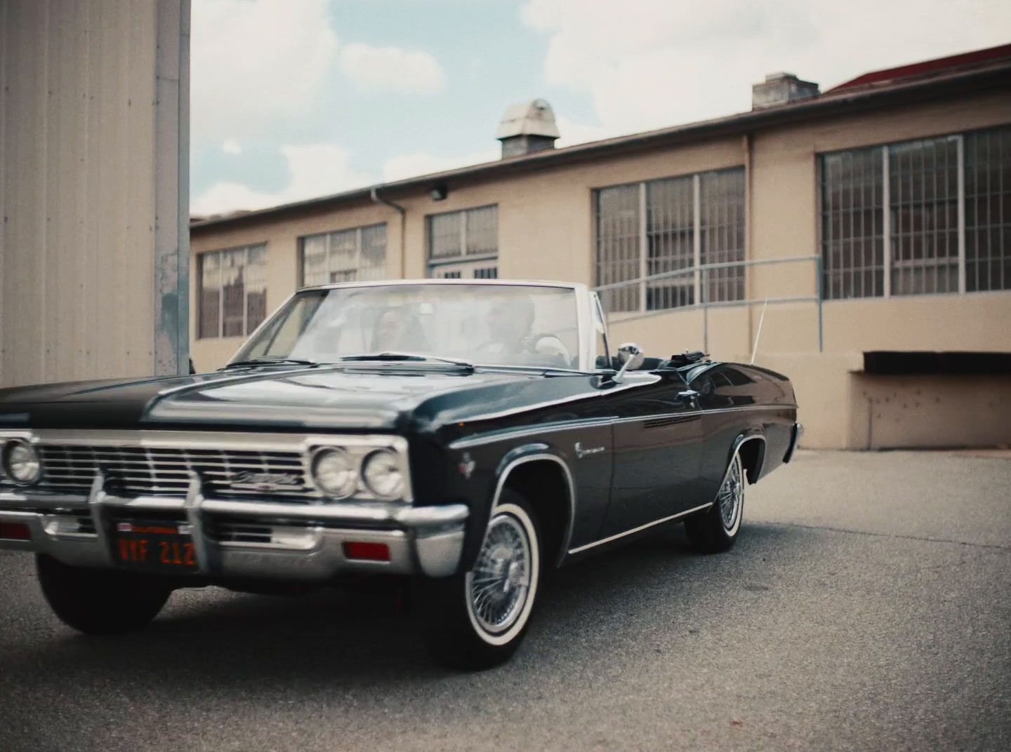 a black car parked in front of a building