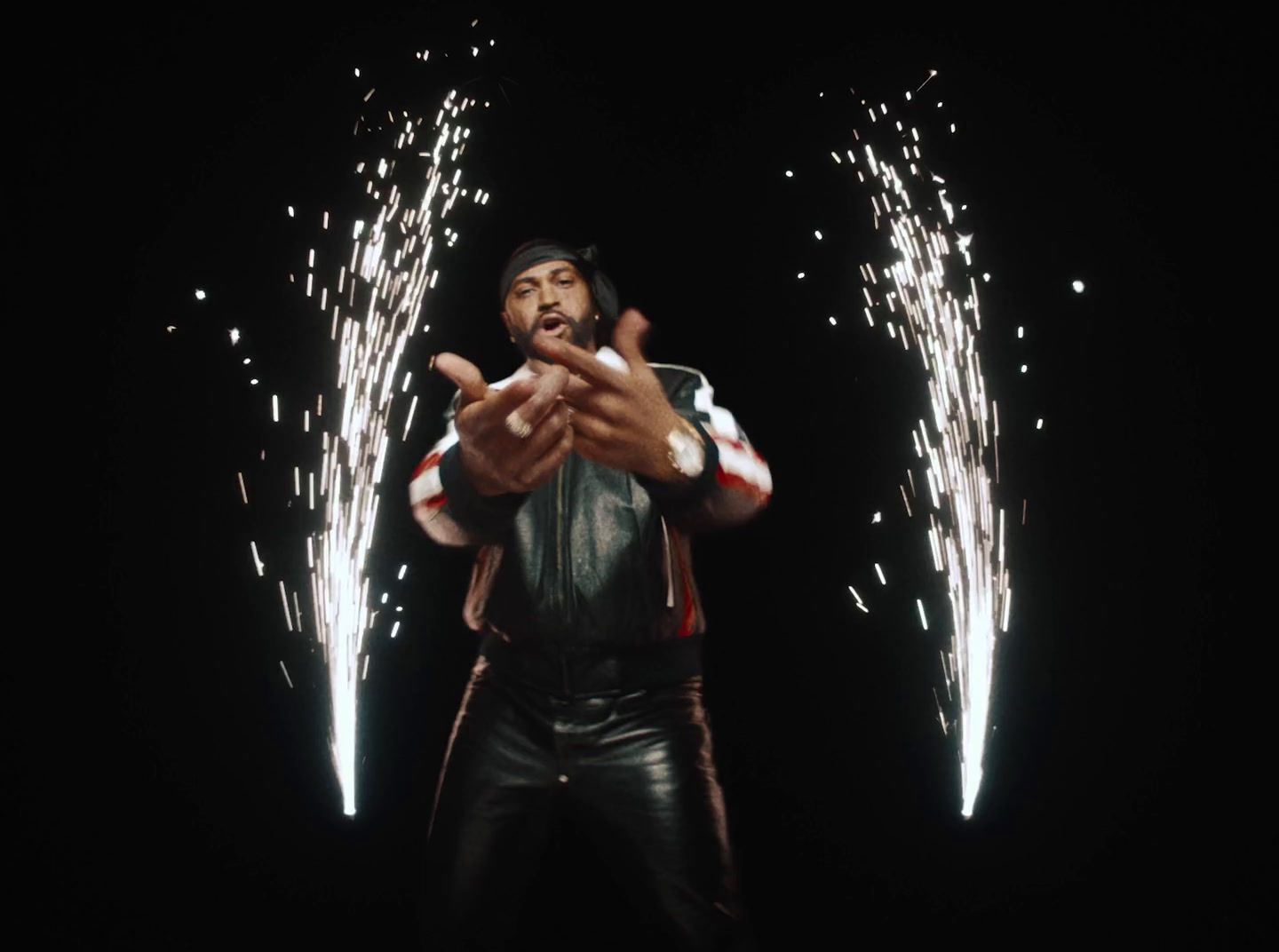 a man standing in front of a firework display