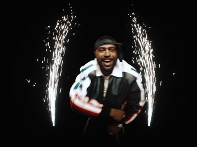 a man standing in front of fireworks in the dark