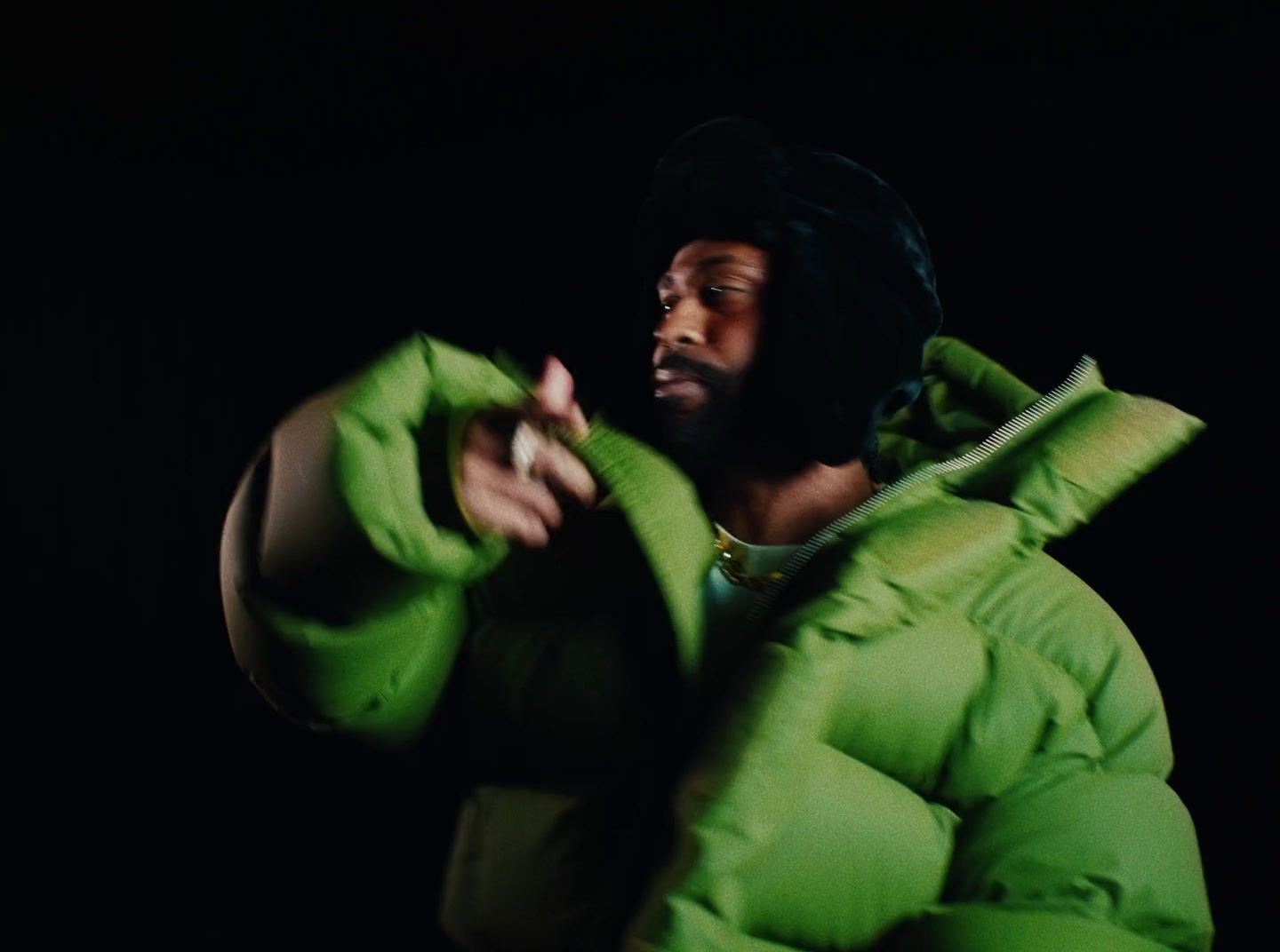 a man in a green puffy coat