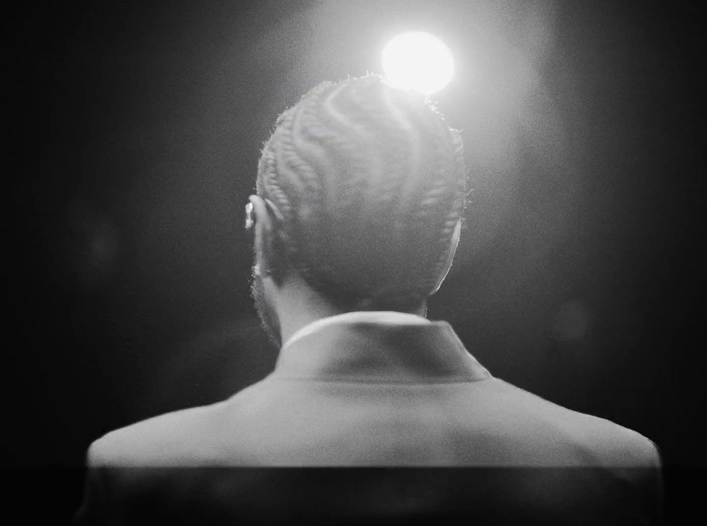 a black and white photo of a woman with a light on her head