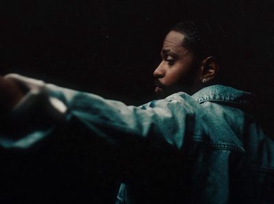 a man pointing a gun at something in the dark