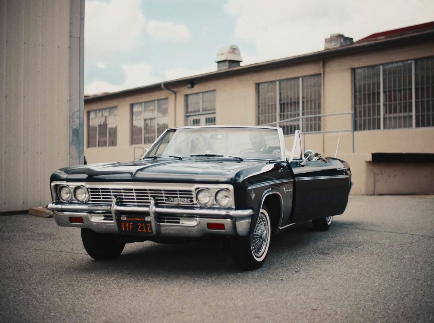 a black car parked in front of a building