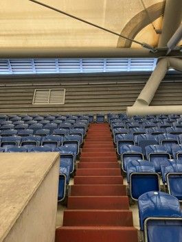 a row of blue seats sitting next to each other