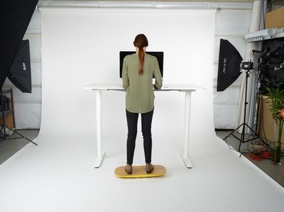 a woman standing in front of a white table