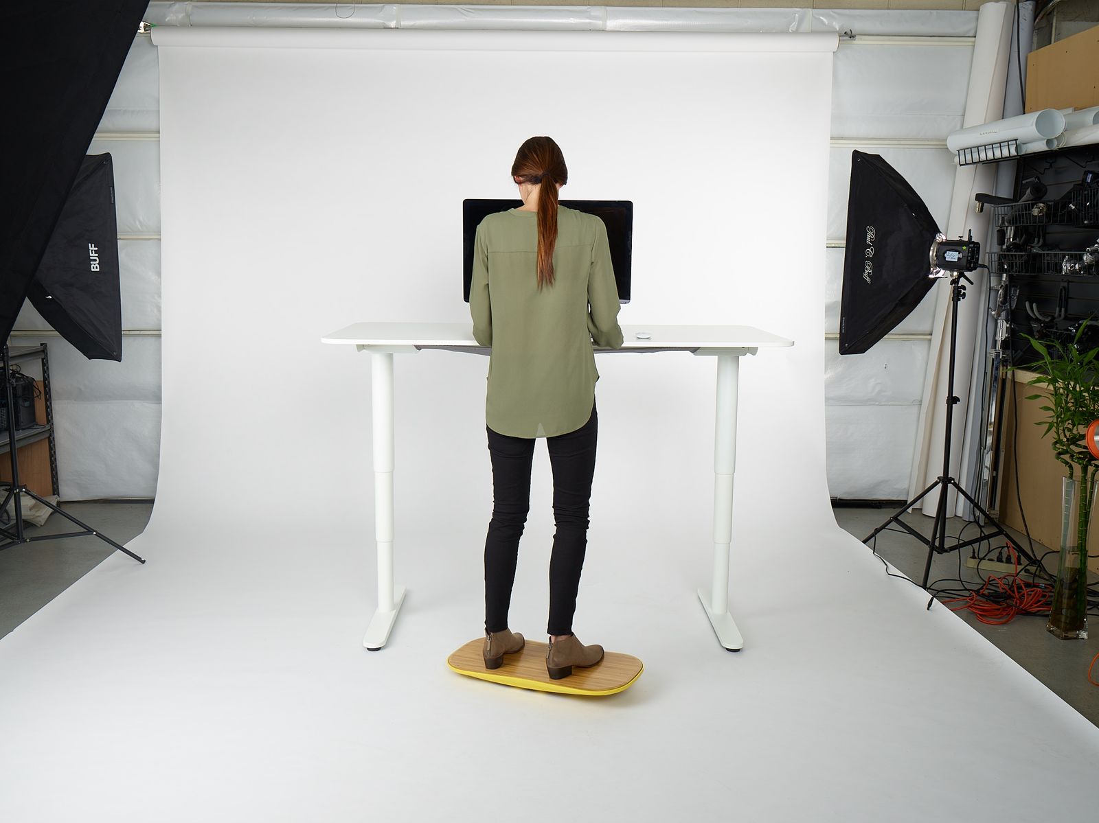a woman standing in front of a white table