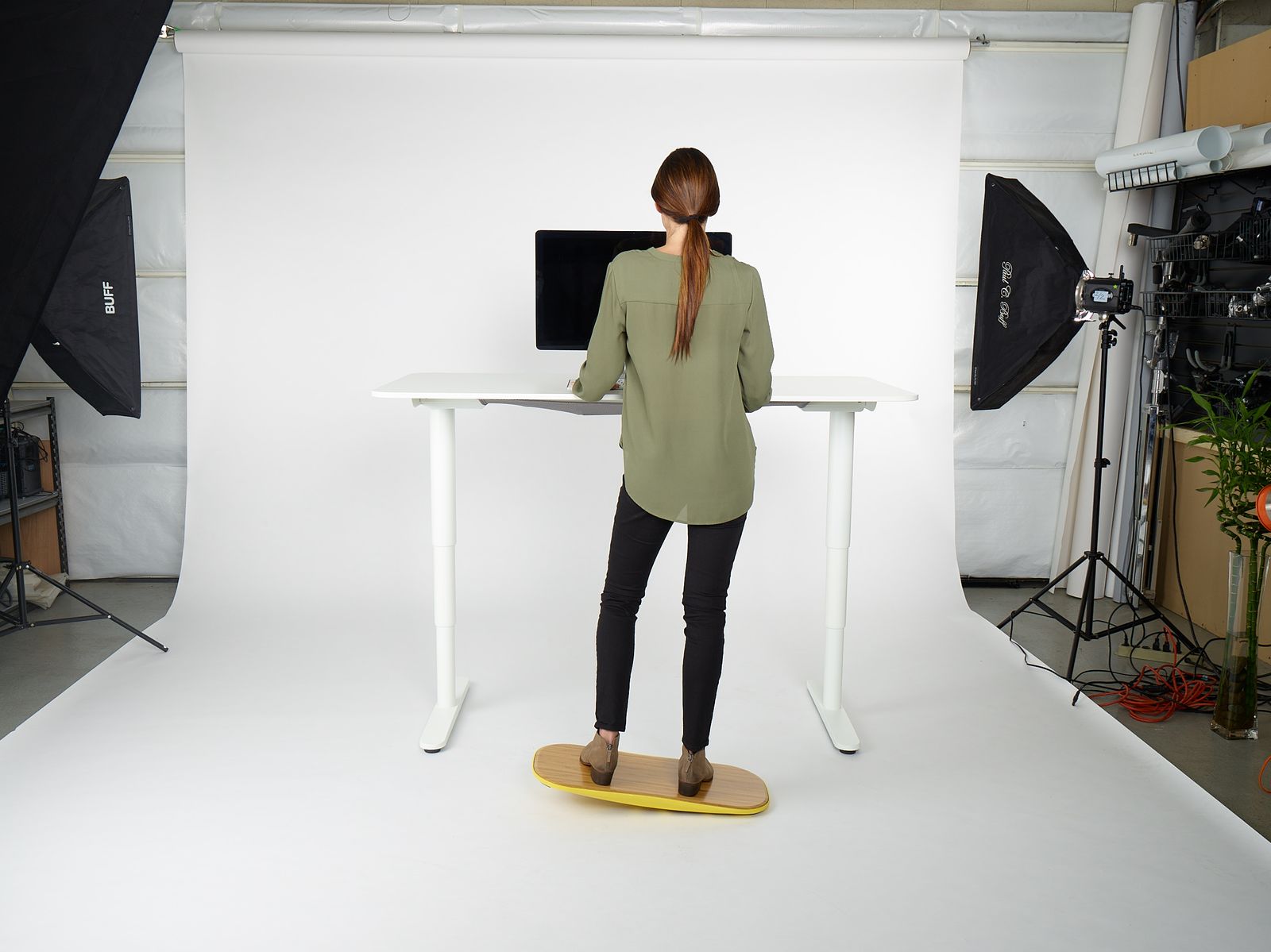 a woman standing in front of a white desk