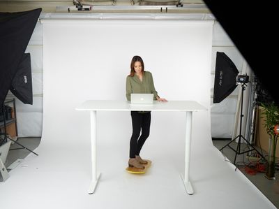 a woman sitting at a table with a laptop