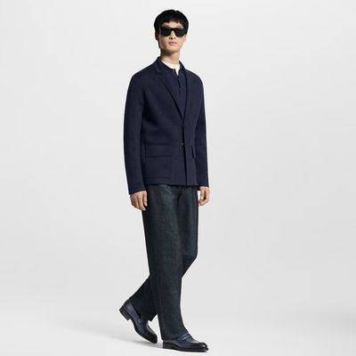 a man in a suit and sunglasses is standing