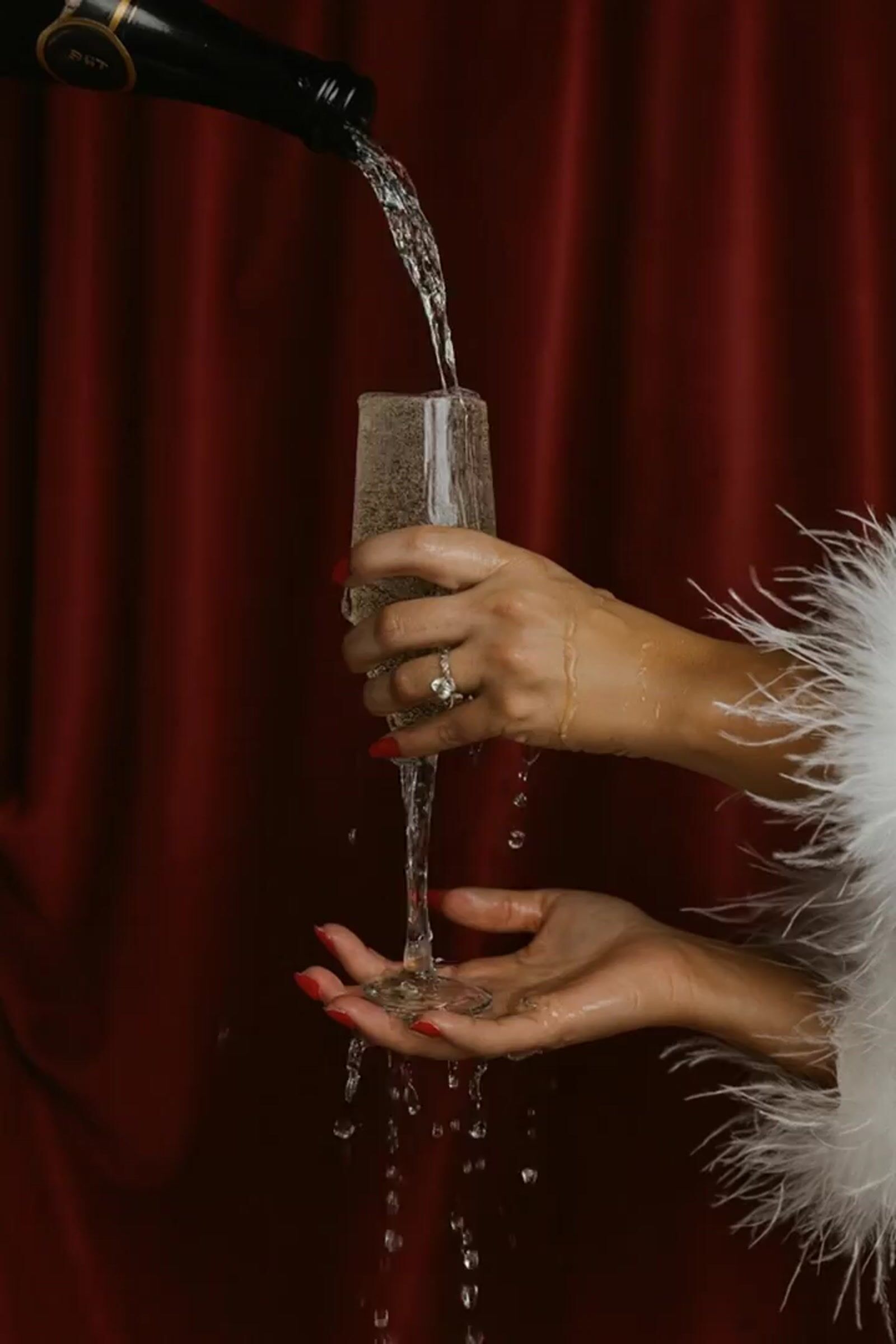 a woman pouring a glass of wine into a wine glass