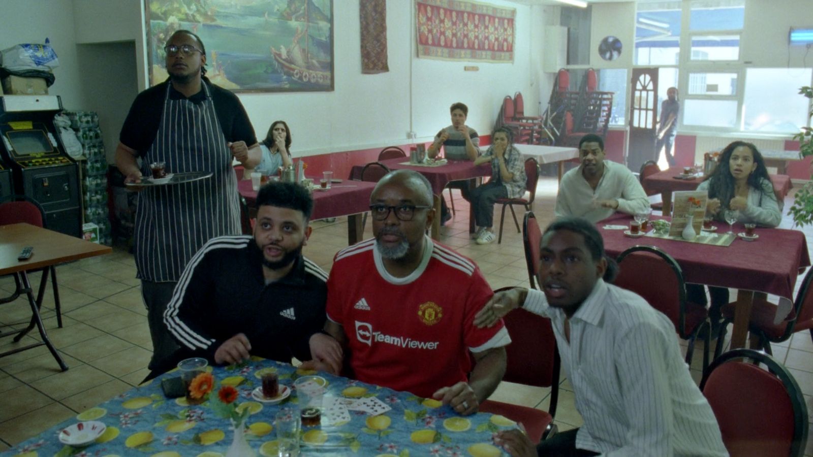 a group of men sitting at a table in a restaurant