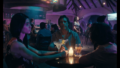 a group of people sitting around a table with drinks