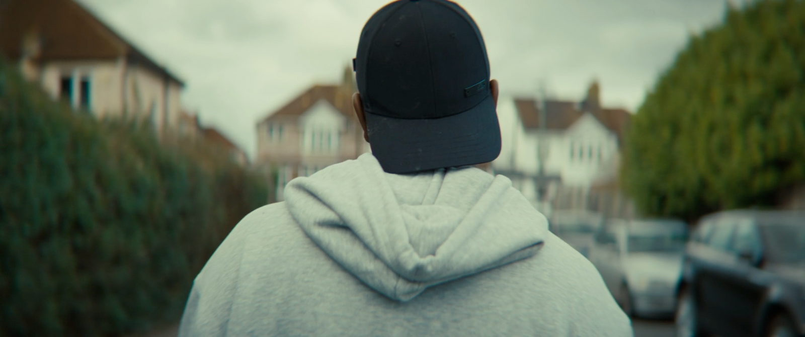 a person with a hat on walking down a street