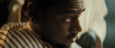 a close up of a person wearing a striped shirt