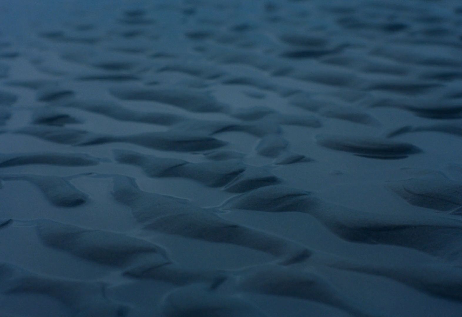 a view of the sand from an airplane window