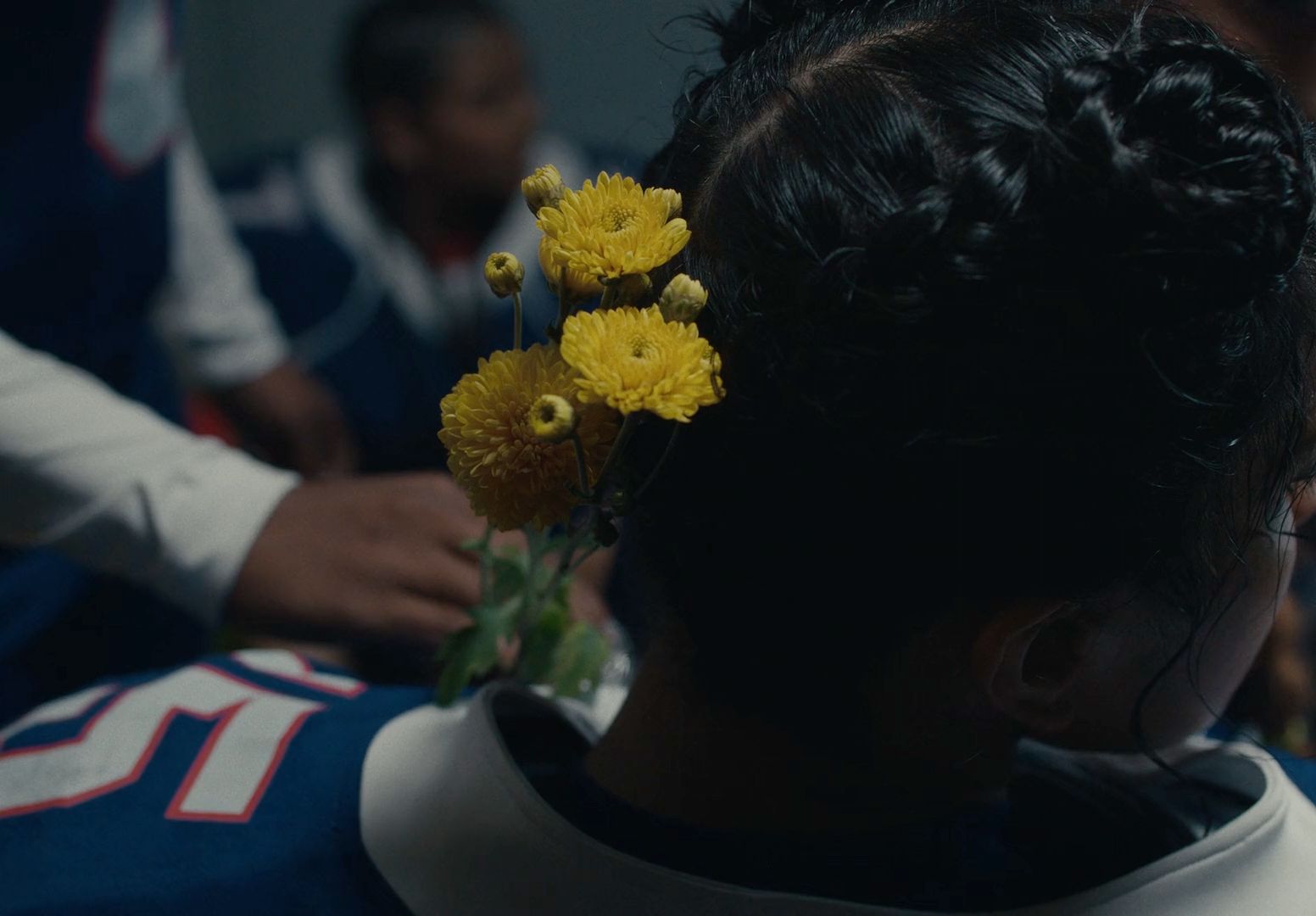 a woman with a bunch of flowers in her hair