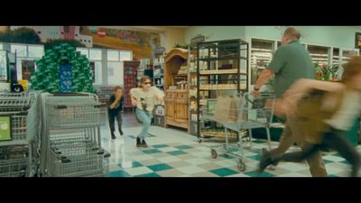 a group of people in a store with shopping carts