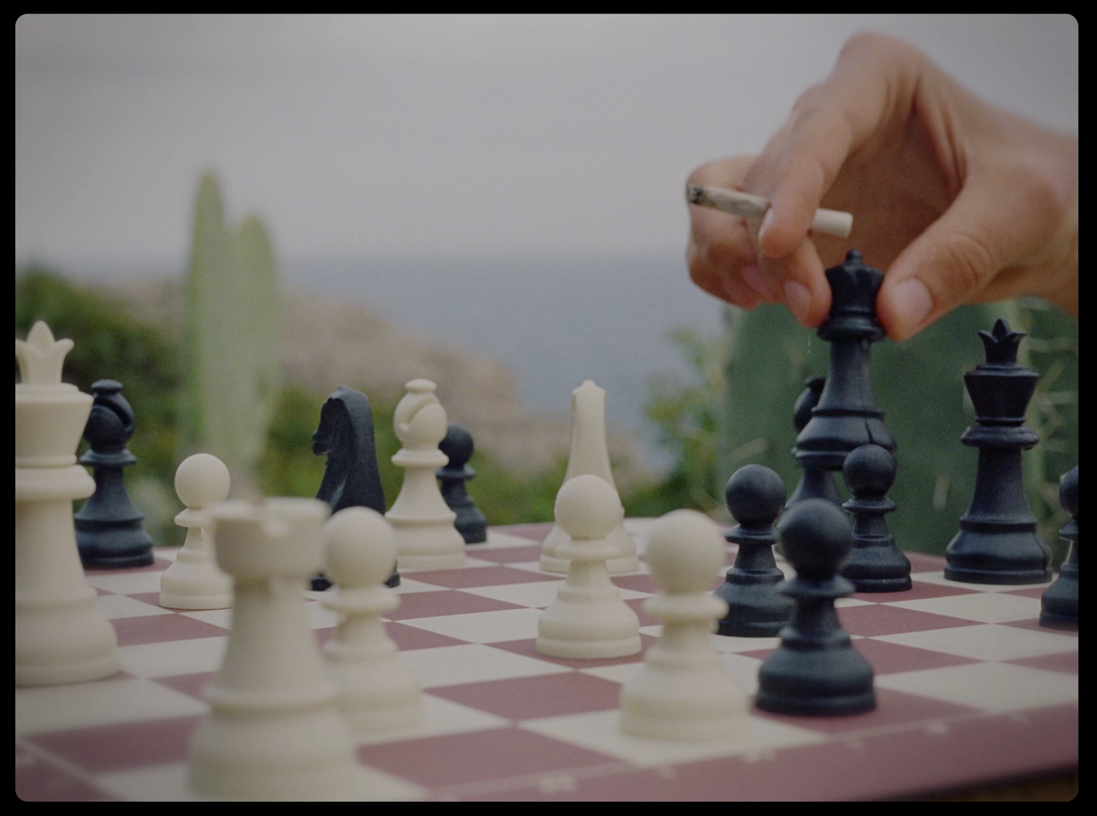 a person playing a game of chess on a checkered board