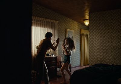 a man standing next to a woman in a bedroom