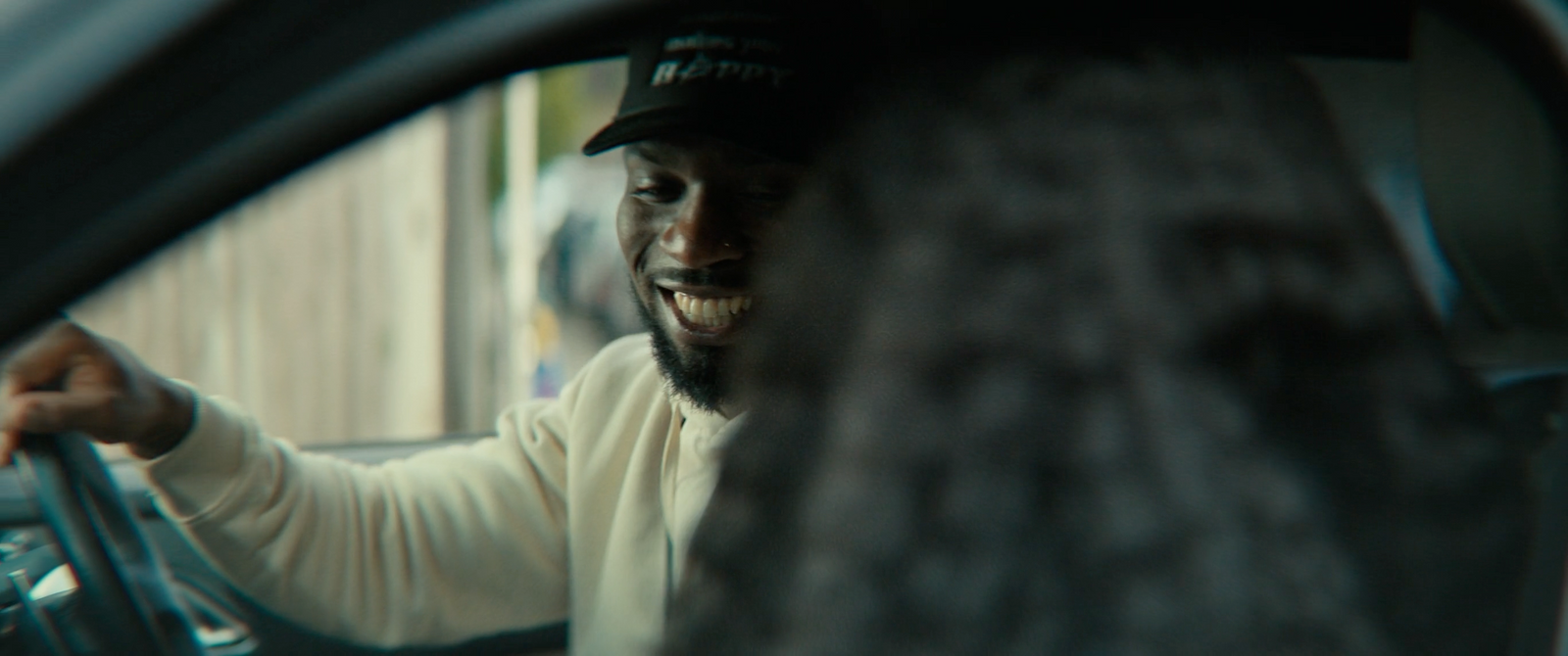 a man driving a car while holding the steering wheel