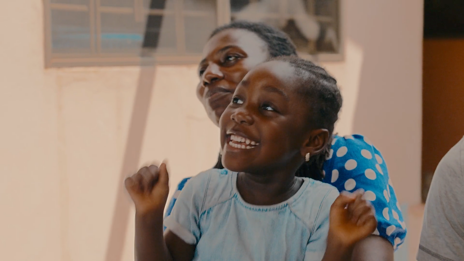 a woman and a young girl are smiling