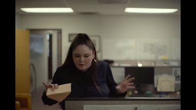 a woman holding a piece of paper in her hands