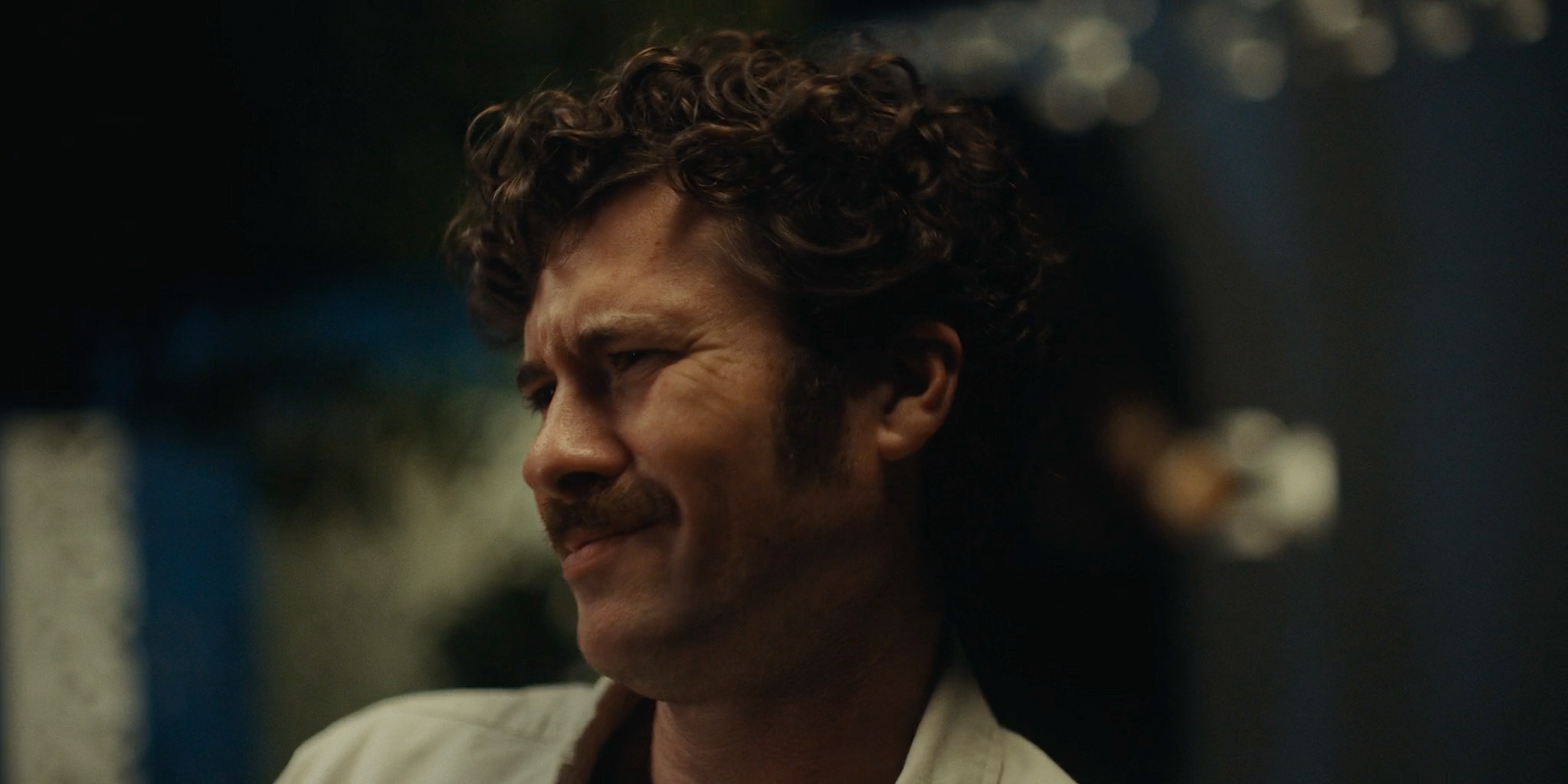 a close up of a person with curly hair