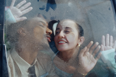 a man and a woman are kissing in a car