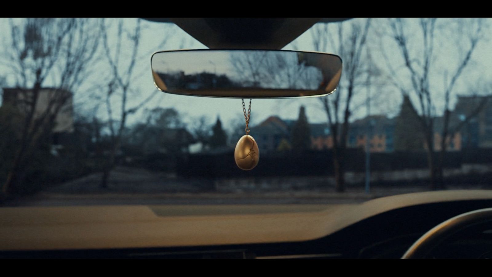 a car dashboard with a mirror hanging from it's side