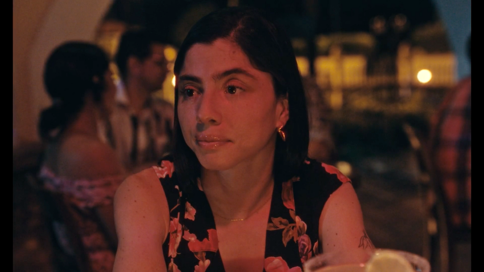 a woman sitting at a table in a restaurant