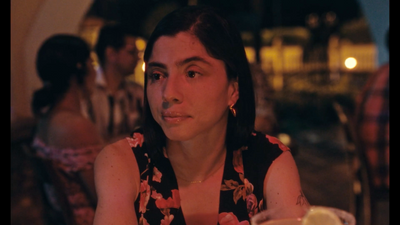 a woman sitting at a table in a restaurant