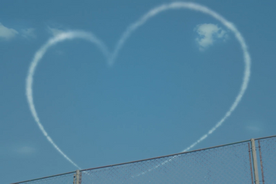 a heart shaped smoke trail in the sky