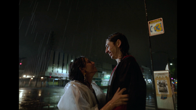 a man and a woman standing under an umbrella