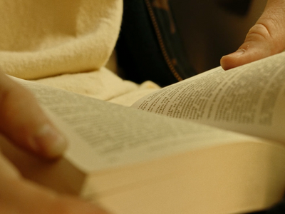 a person is reading a book with their hands