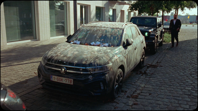 a dirty car parked on the side of the road