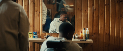 a man sitting in a chair in front of a mirror