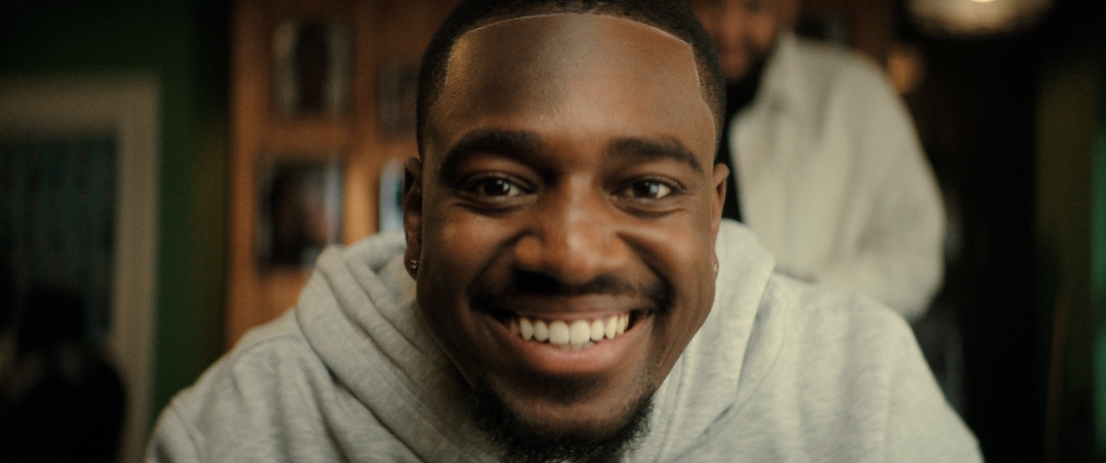 a man with a goatee smiles at the camera