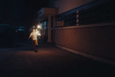 a person walking down a street at night