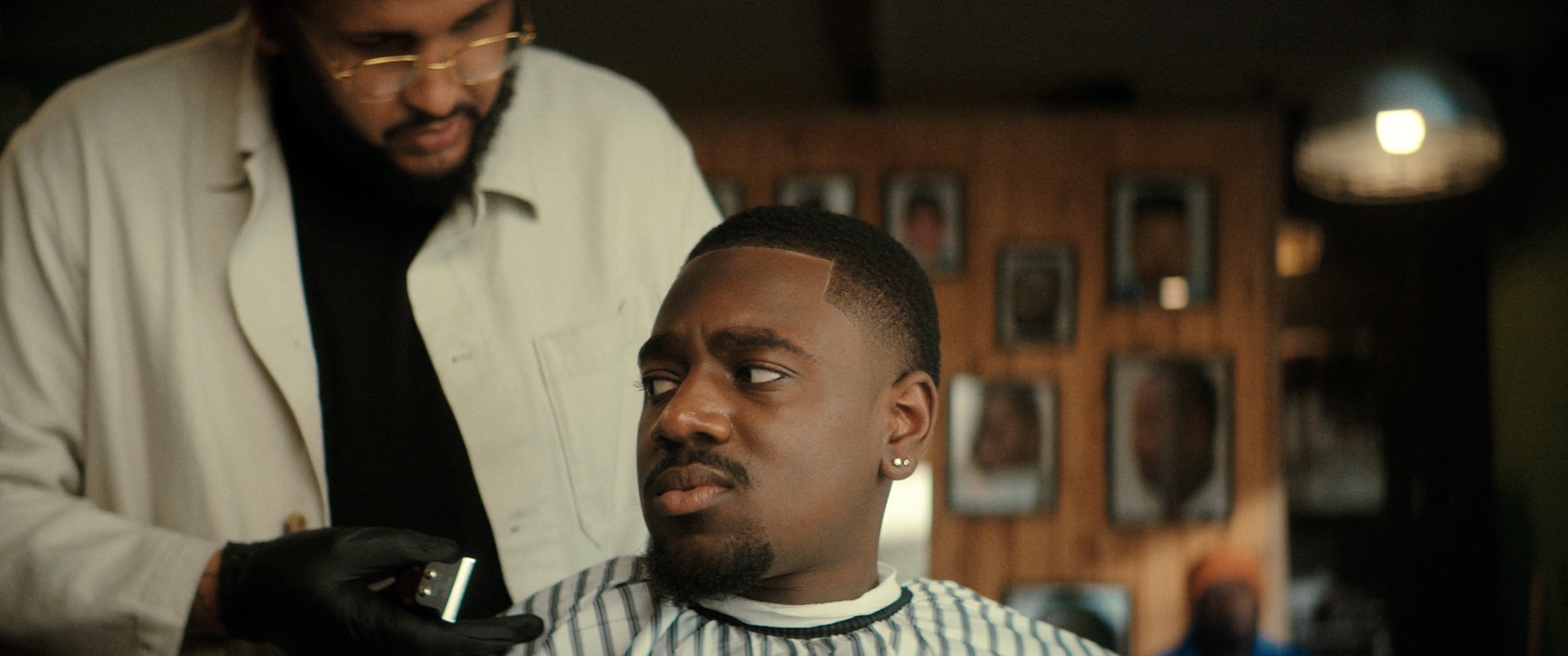 a man getting his hair cut by a barber