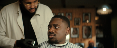 a man getting his hair cut by a barber