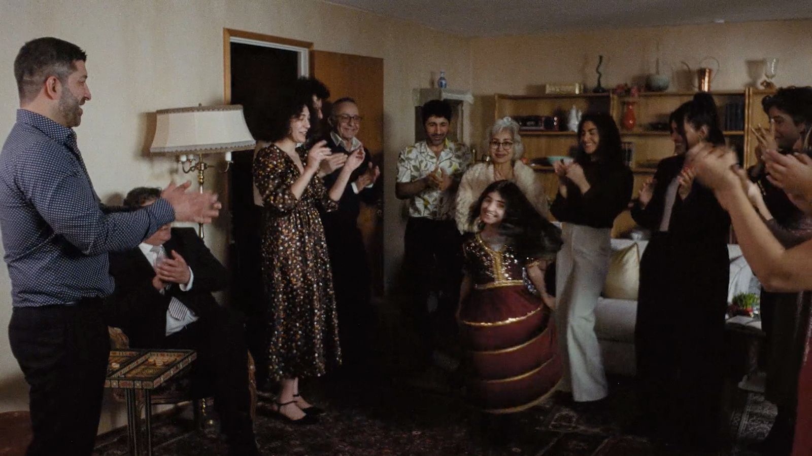 a group of people standing around a living room