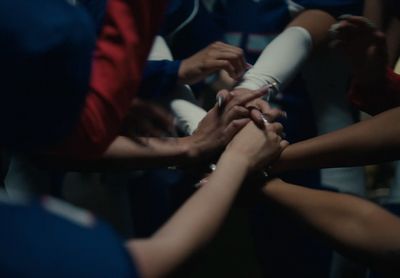 a group of people putting their hands together