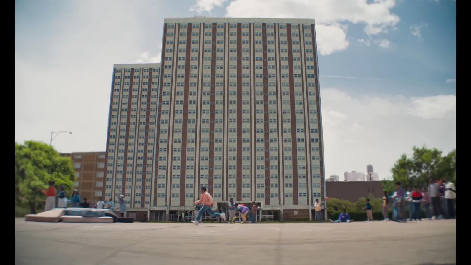 a group of people standing in front of a tall building