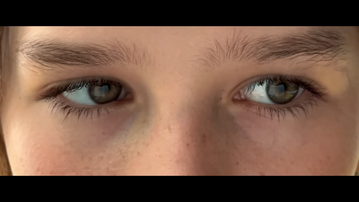 a close up of a person's blue eyes