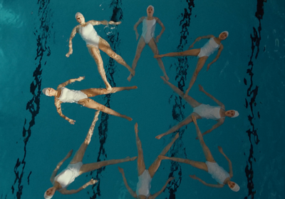 a group of people floating on top of a body of water